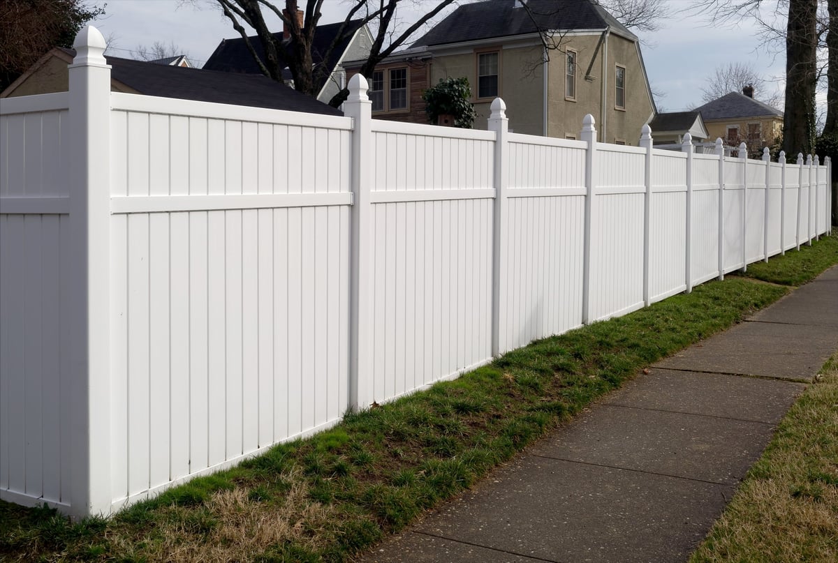 Beautiful white vinyl fence in residential neighborhood