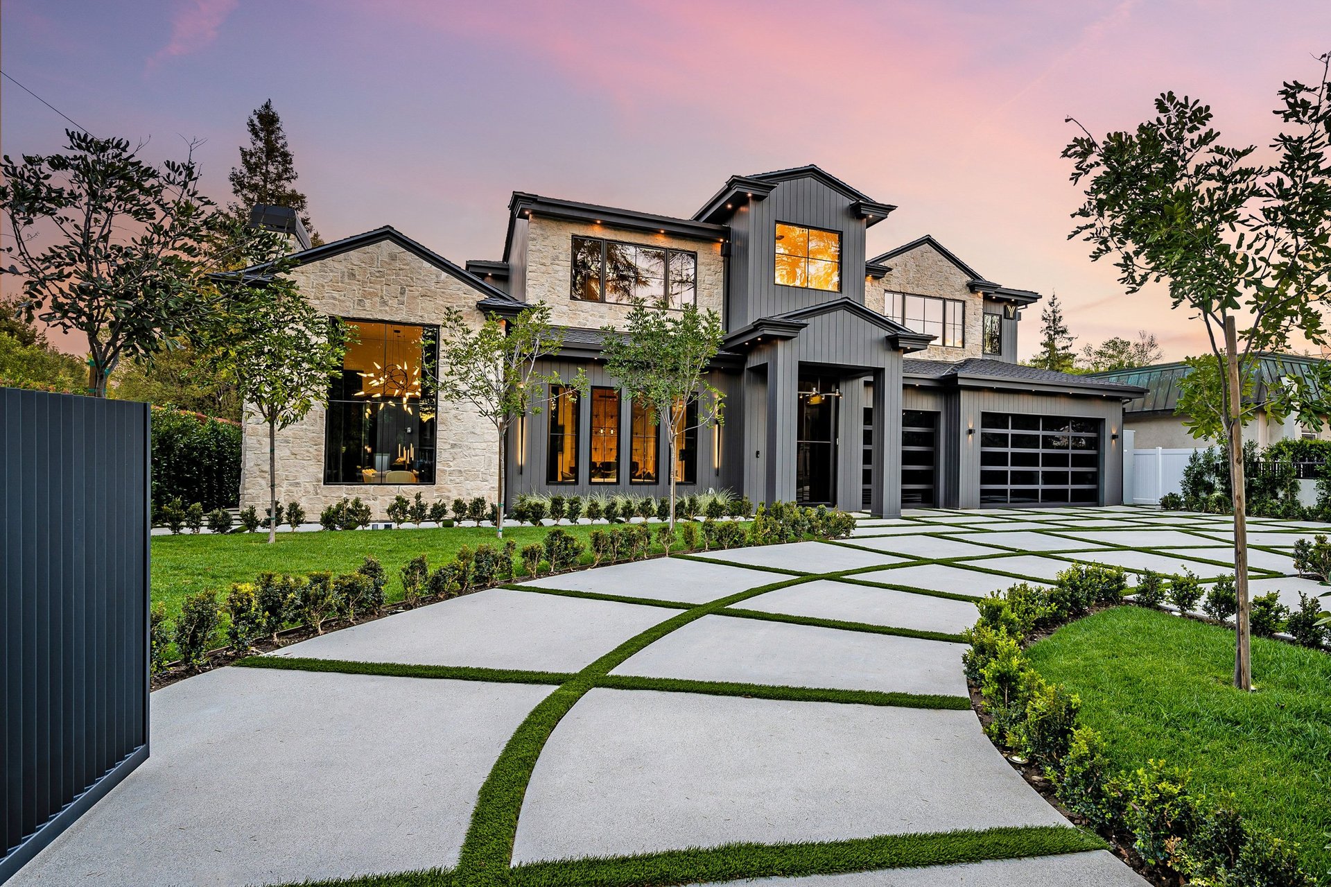 Modern luxury home exterior with clean landscaping and vinyl fence